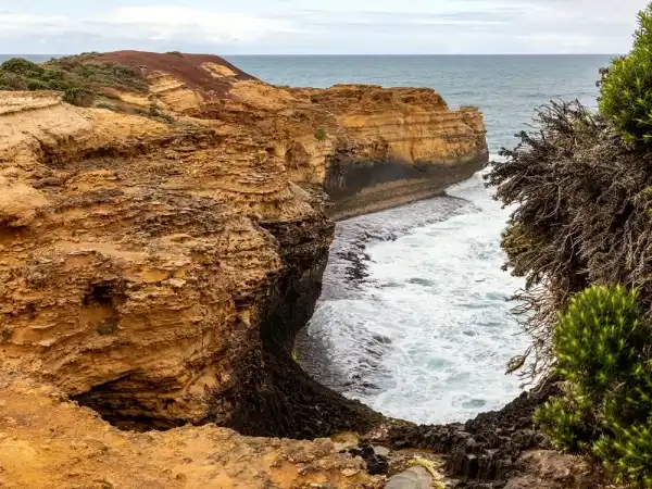 Limestone cliffs meeting a clear sea