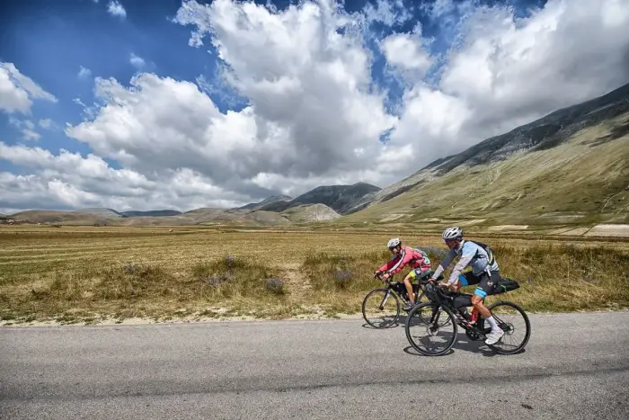 A cyclist riding a bike along a country road