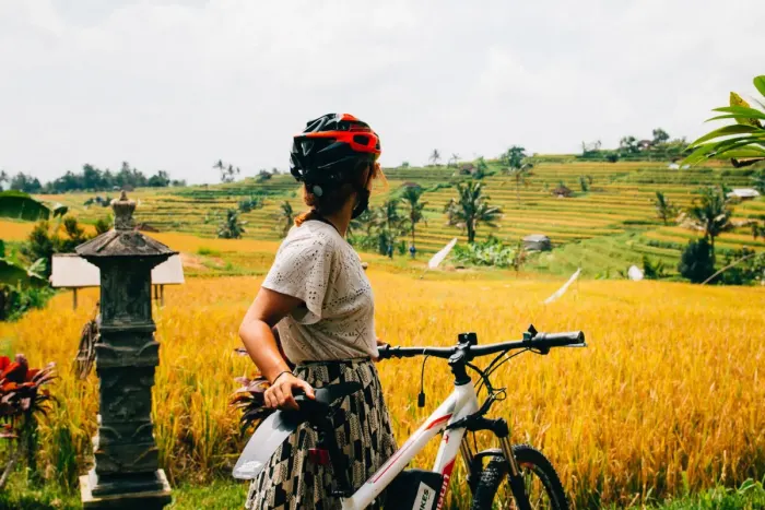 A cyclist riding a bike along a country road