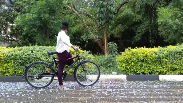 A cyclist riding a bike along a country road