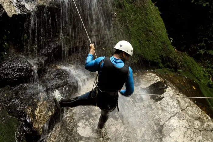 Canyoners descending a gorge on a rope