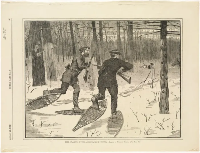 Snowshoers walking in single file across deep snow