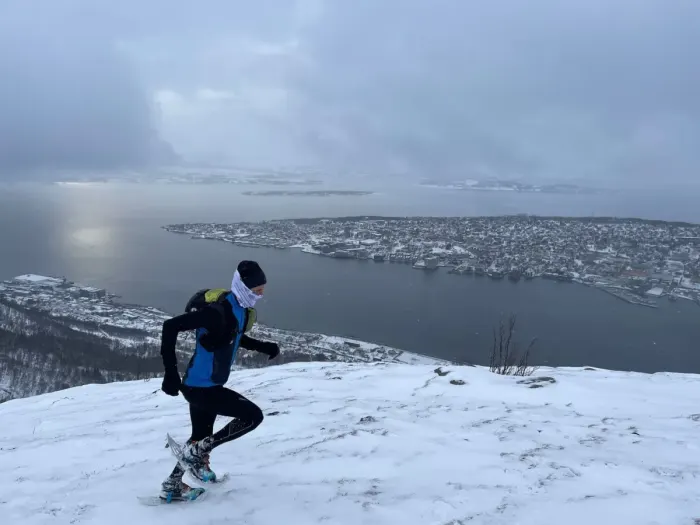 Snowshoers walking in single file across deep snow