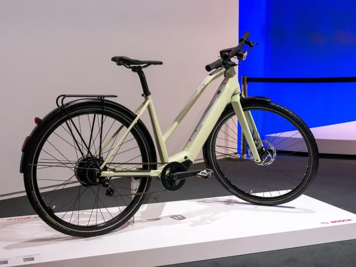 An electric bike on a gravel path with the motor and battery visible
