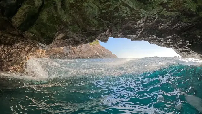 A snorkeler floating face down in clear shallow water
