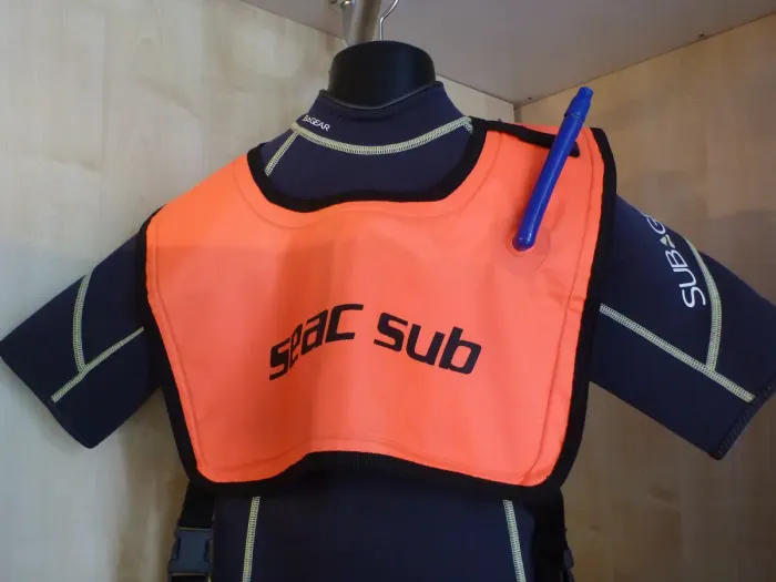 A snorkeler floating face down in clear shallow water