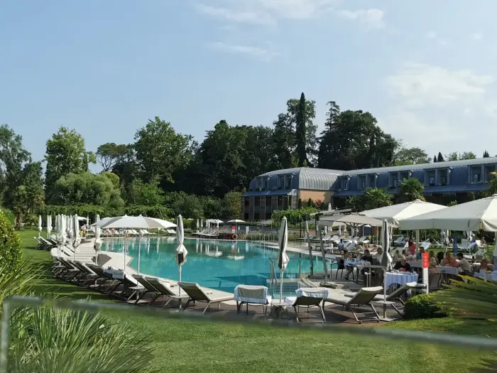 An outdoor thermal pool with steam rising off the water