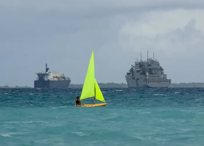 A small sailing boat under sail on open water