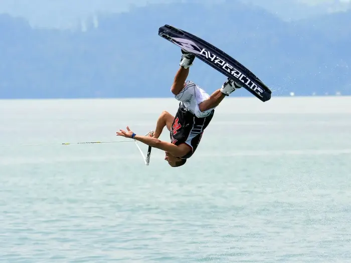 A wakeboarder inverted above the water